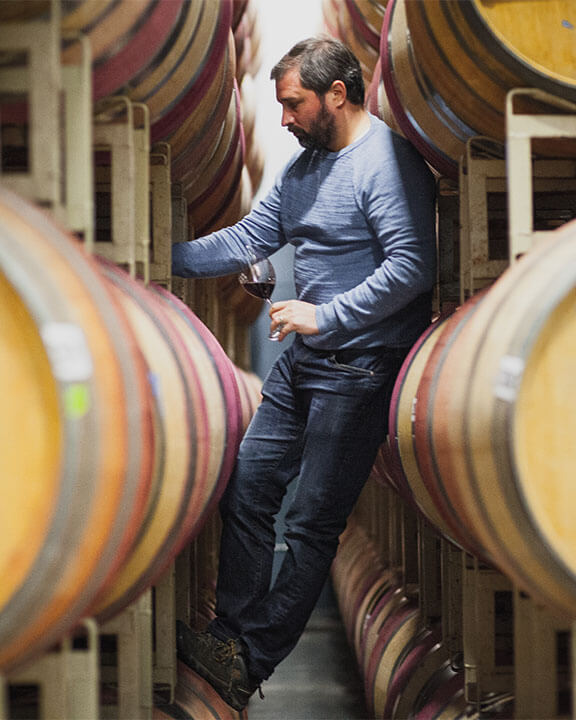 jason gorski standing with wine barrels